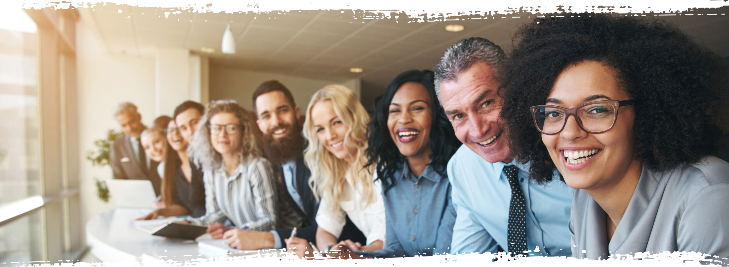 Office workers in a line smiling